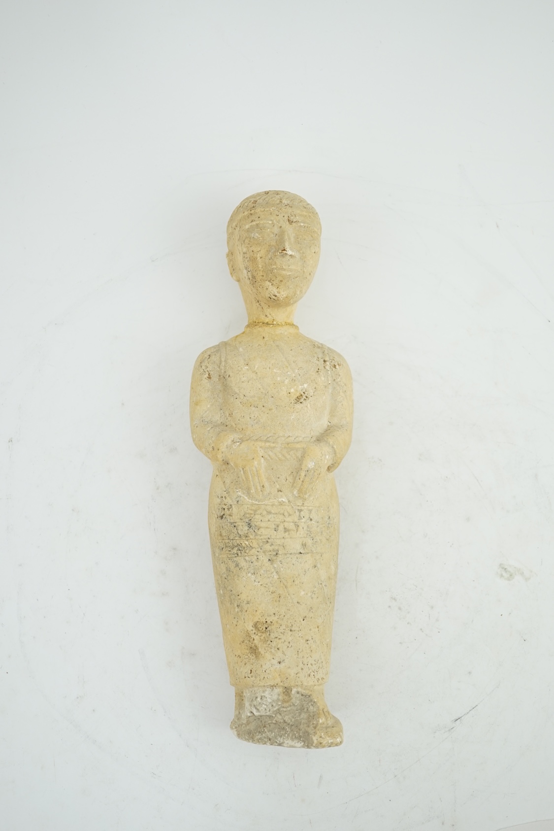 An unusual limestone votive figure, with cuneiform inscription, possibly Mesopotamian